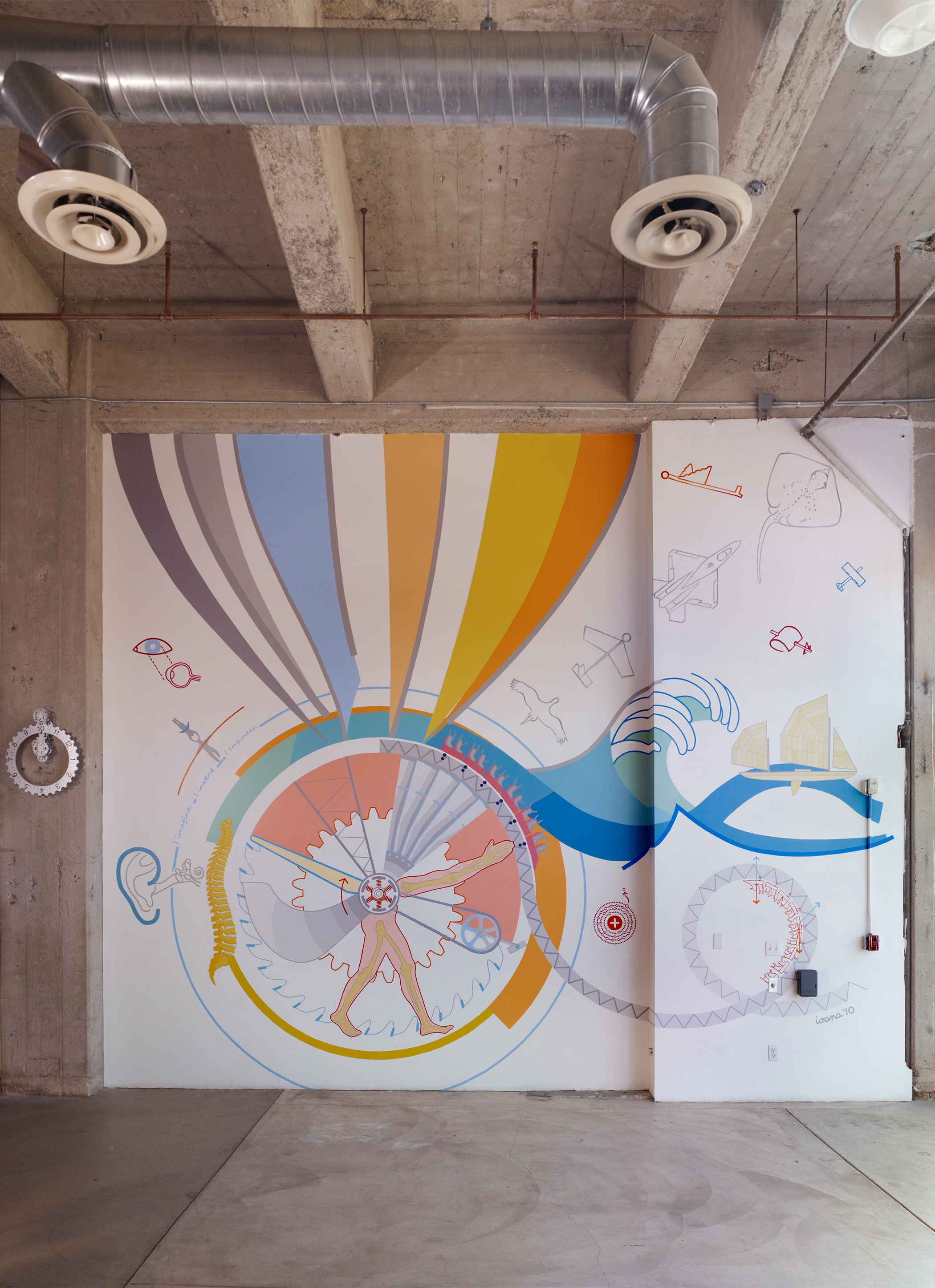 A mural in pinks, oranges, yellows, blues, blue-greens, and greys is seen inside its industrial setting, framed by a concrete floor, a concrete wall, and a concrete ceiling. 
                                                        Large air ducts hang below the concrete beams.
                                                        The mural consists of large round area with a giant saw blade and a giant gear in the background, on top of which things rotate around a simple motor: 
                                                            a wind-turbine blade, a truss, part of a jet turbine, an arm, a bike gear, legs, and a propeller plane blade.
                                                        A wave and a rollercoaster start off the top of it.
                                                        An atom, an eye, an ear, and a person balancing are drawn around it.
                                                        A wave chasing a sailing canoe and the rollercoaster expand to the right, while a series of bird to paper airplane to fighter jet to stingray shoot diagonally right above.
                                                        An abstract giant hot air balloon rises above the central round area.