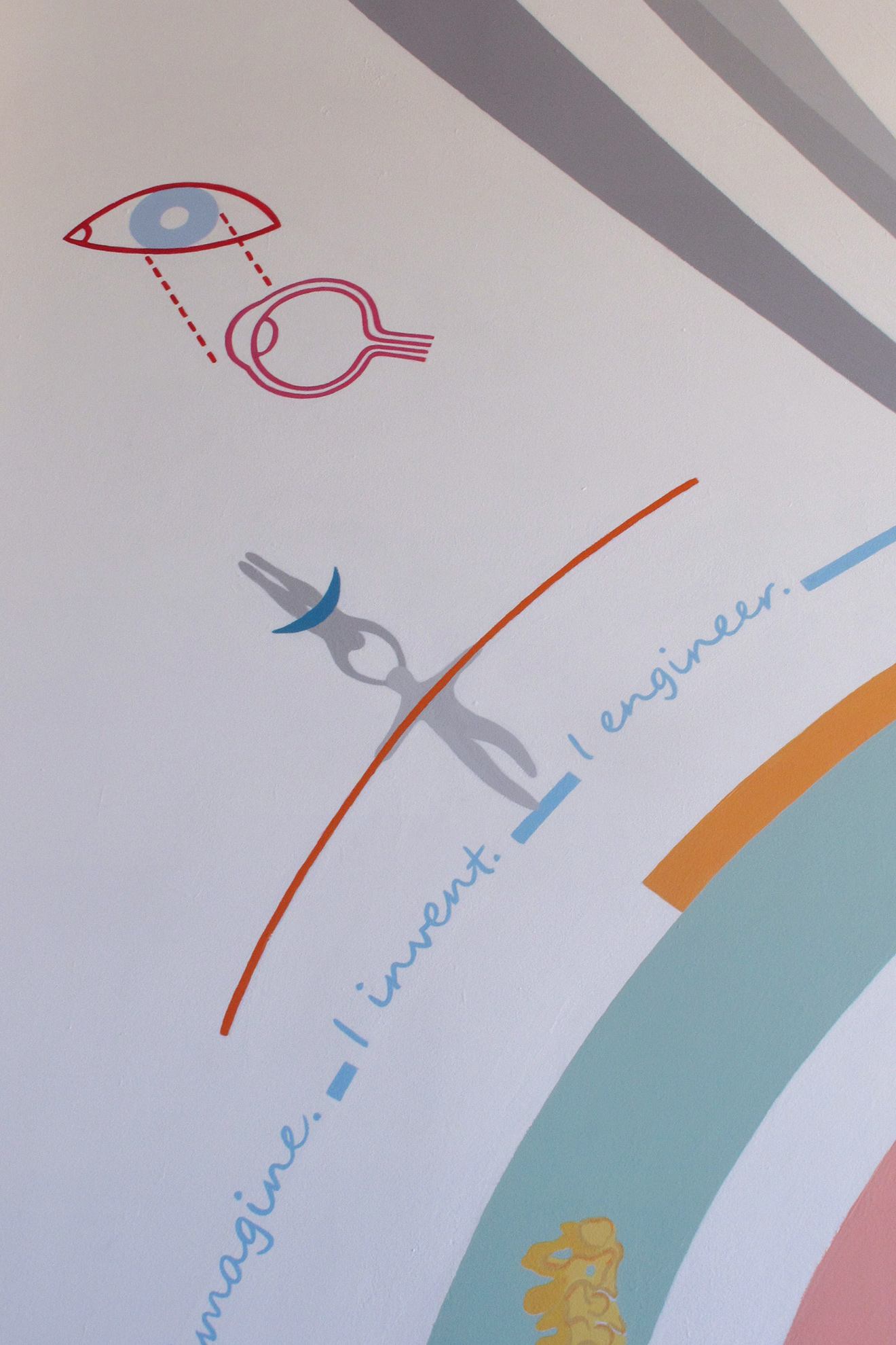 Zoom in on abstract grey acrobat supporting an upside down lady acrobat on his head while holding 
                                                                            a long red stick to balance.
                                                                            Above that is a diagram of the eye in front and section views in magenta and light blue.
                                                                            Iridescent&rsquo;s motto: &ldquo;I imagine. I invent. I engineer. &rdquo; is written in blue below.