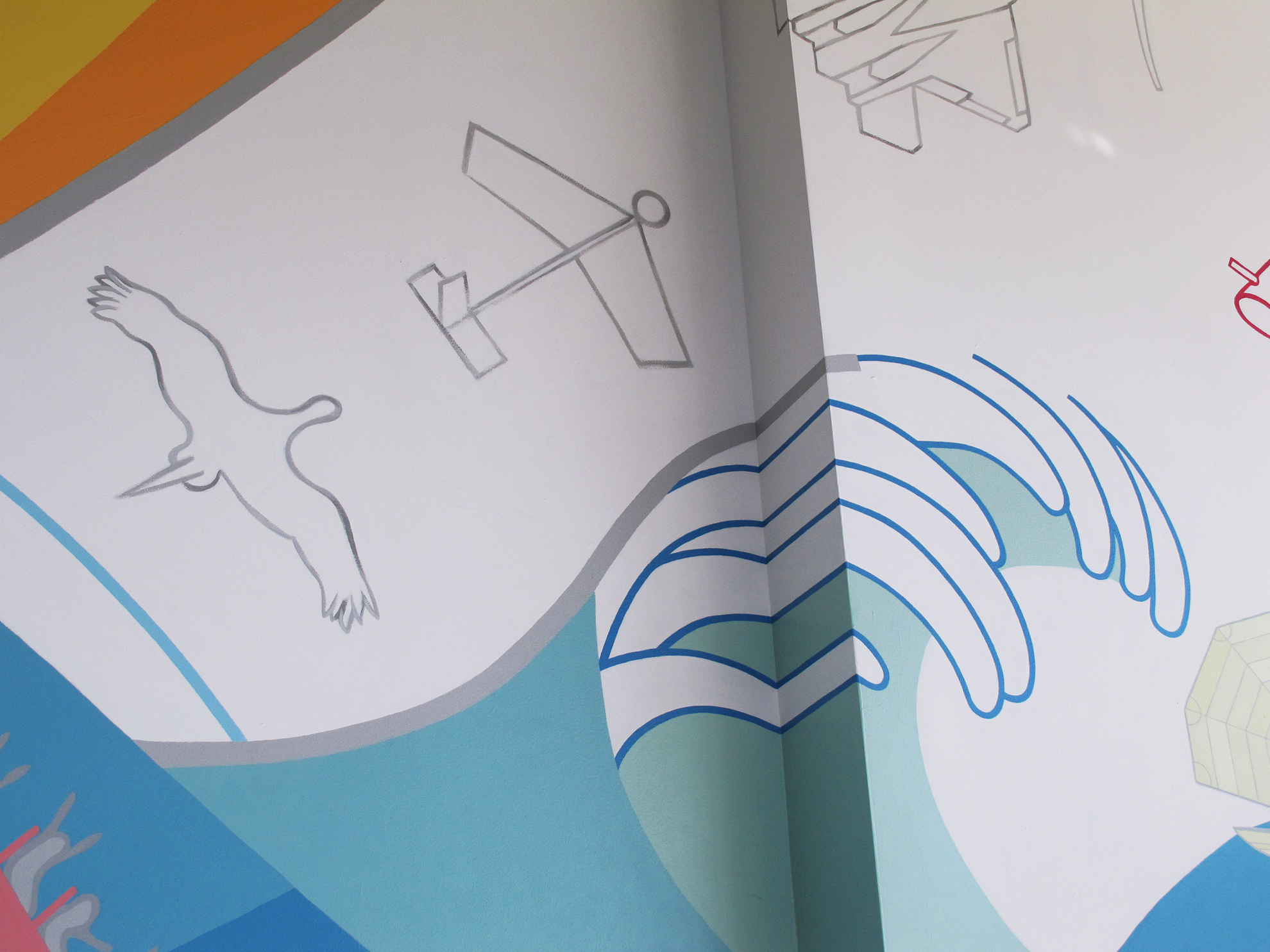 Zoom in on area of mural with the progressive grey line paintings of a bird, a paper airplane, a fighter jet... in a diagonal line up,
                                                                    and the very graphic blue and white frothy part of the wave as it crosses the area of the wall where one wall pops out 6-10 inches.