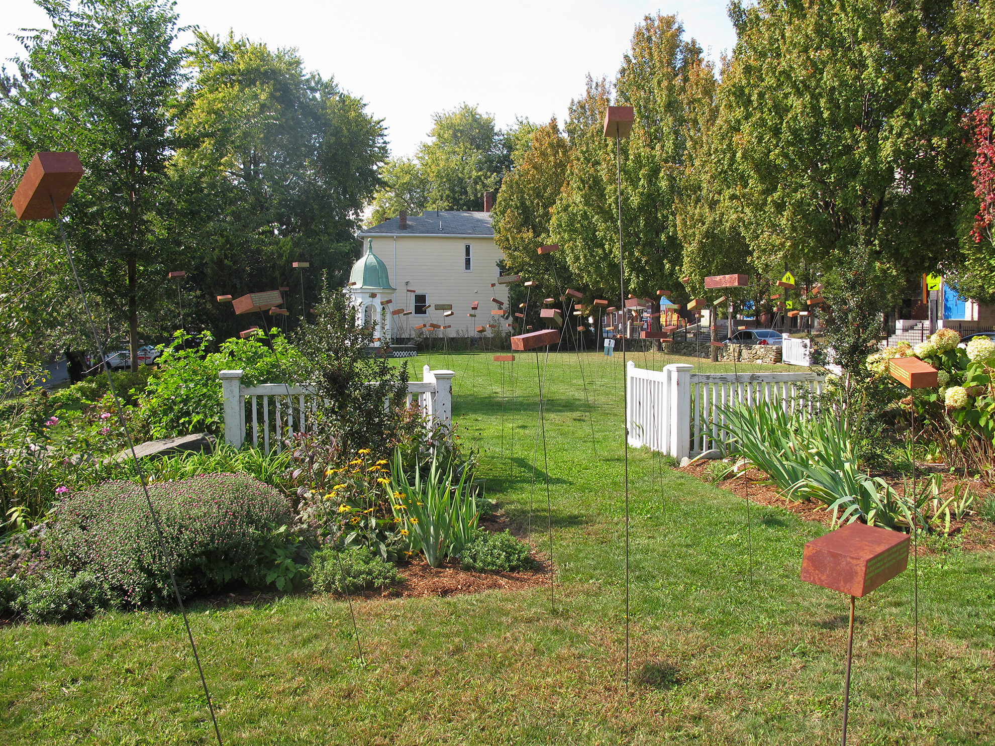 field of seemingly floating fake bricks is seen from a distance in the historic Shirley Eustis House garden