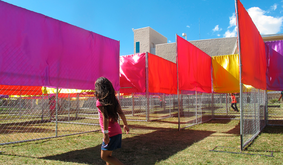 girl walking around art installation